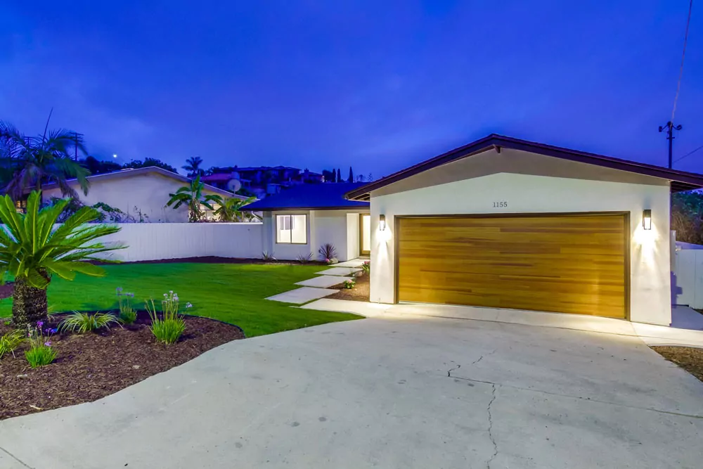 CHI flush horizontal wood-look garage door installed at La Jolla home at dusk