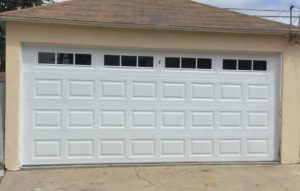 Dark walnut flush horizontal steel garage door single car on rendered home